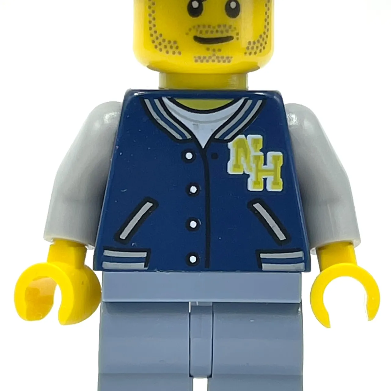 Man, Dark Blue Letterman Shirt with 'NH', Sand Blue Legs, Dark Blue Cap, Stubble